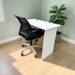 White study desk with black swivel mesh office chair for home study and workspace